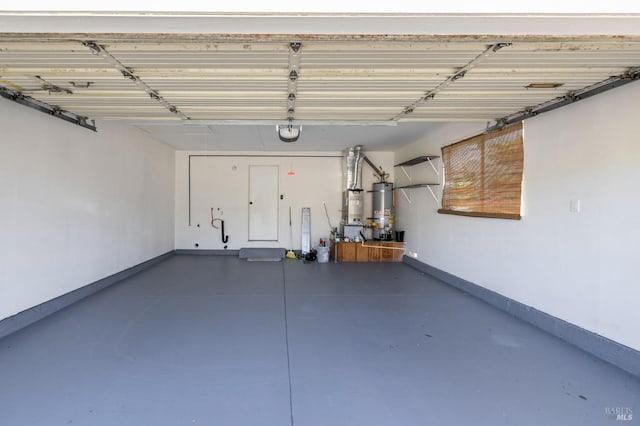 garage featuring water heater, baseboards, and a garage door opener