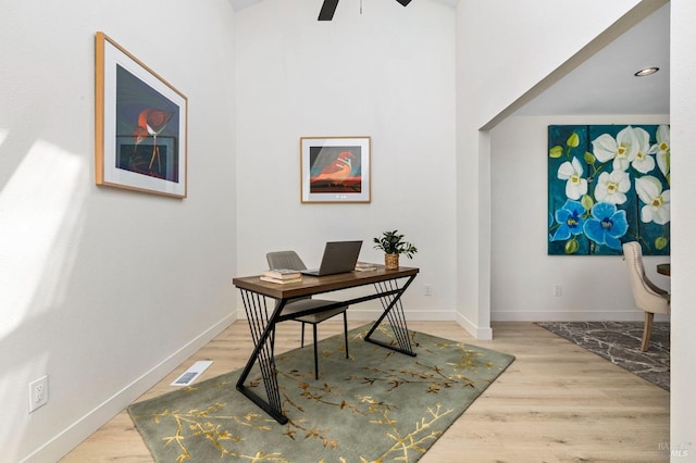 home office featuring baseboards, wood finished floors, and visible vents