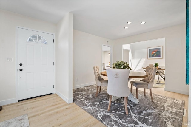 dining room featuring baseboards, recessed lighting, and wood finished floors