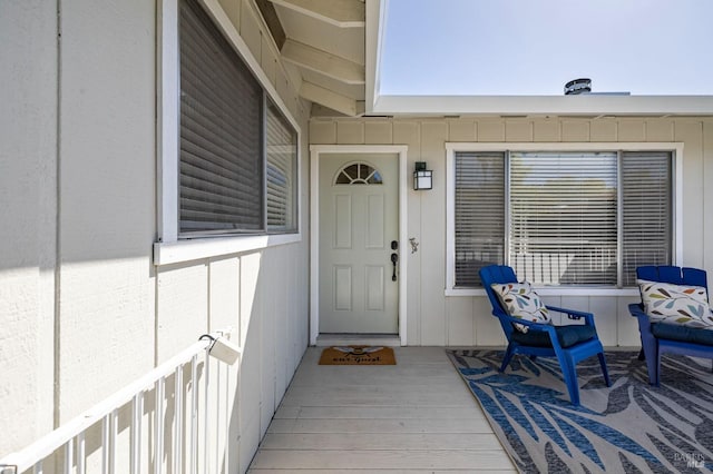 property entrance featuring board and batten siding