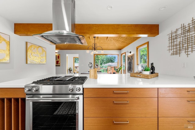 kitchen featuring light countertops, high end stove, beamed ceiling, and island exhaust hood