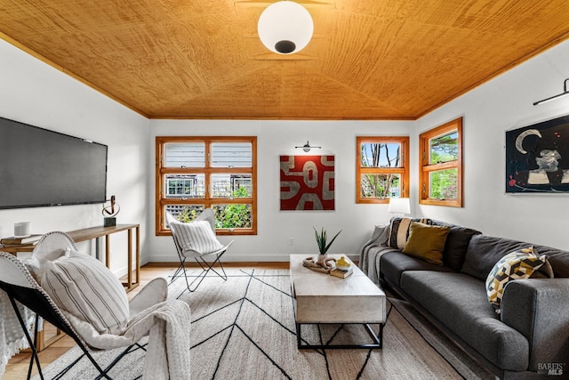 living area with baseboards, wood ceiling, and light wood-style floors