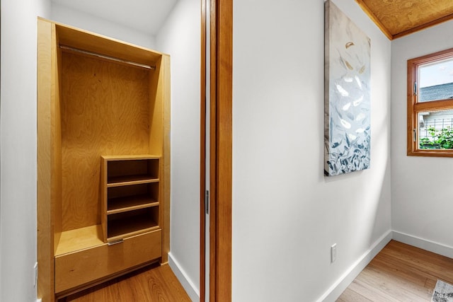 interior space featuring baseboards and wood finished floors
