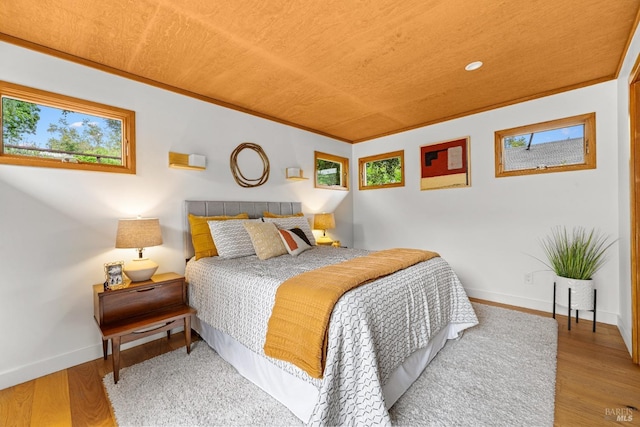 bedroom with baseboards and wood finished floors