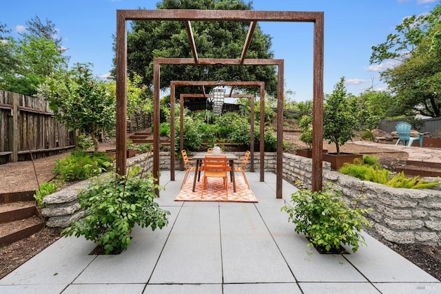 view of patio featuring a fenced backyard and outdoor dining space