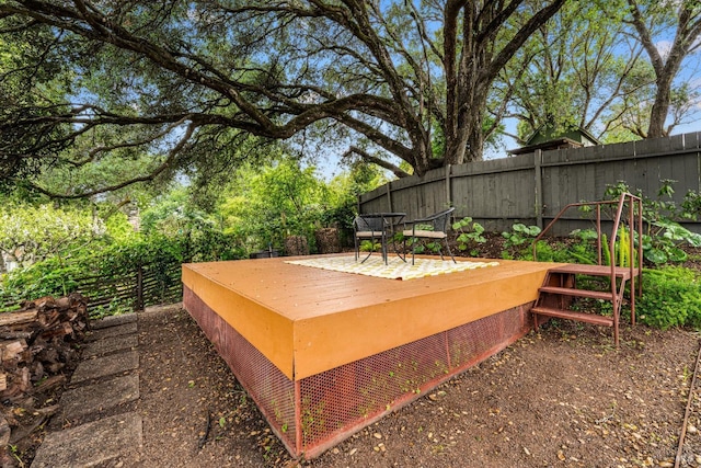 exterior space featuring fence and a wooden deck