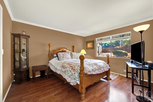 bedroom featuring baseboards, ornamental molding, and wood finished floors