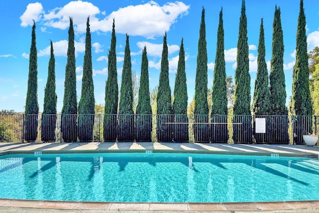 community pool featuring fence