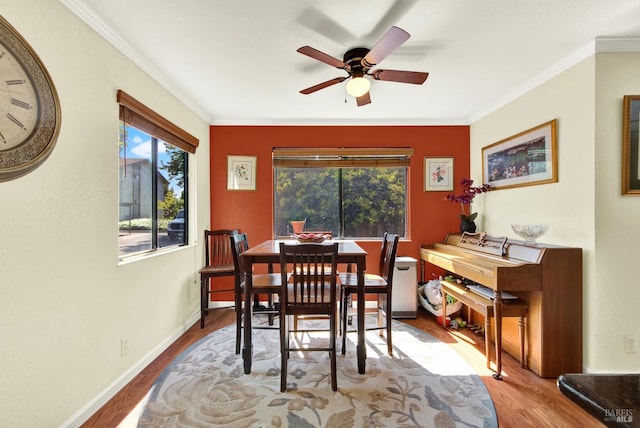 dining area with ornamental molding, wood finished floors, and a wealth of natural light