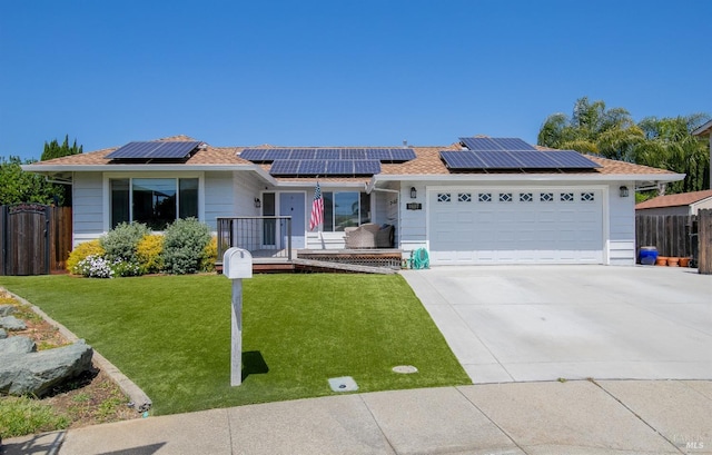 ranch-style home featuring fence, solar panels, driveway, a front yard, and an attached garage