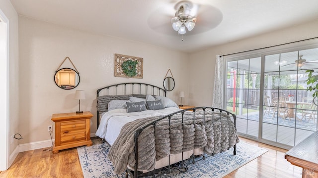 bedroom with baseboards, a ceiling fan, wood finished floors, and access to outside