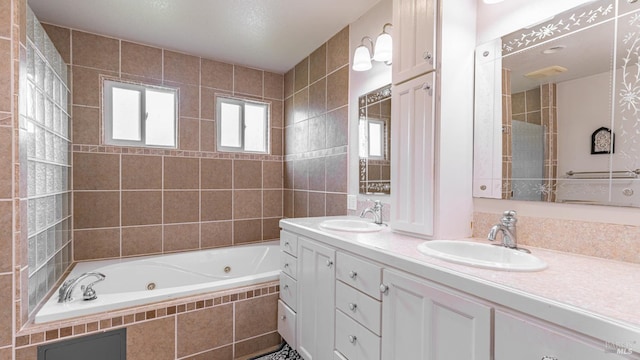 full bath featuring double vanity, a whirlpool tub, and a sink