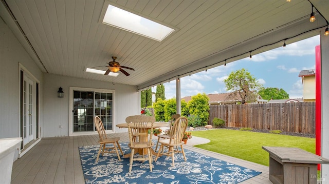 exterior space with outdoor dining space, a wooden deck, a ceiling fan, and a fenced backyard