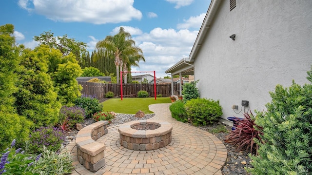 view of patio / terrace featuring a fire pit and a fenced backyard