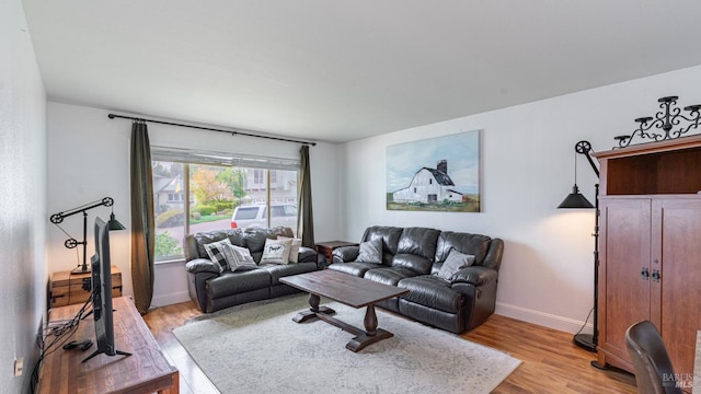 living room featuring baseboards and light wood finished floors