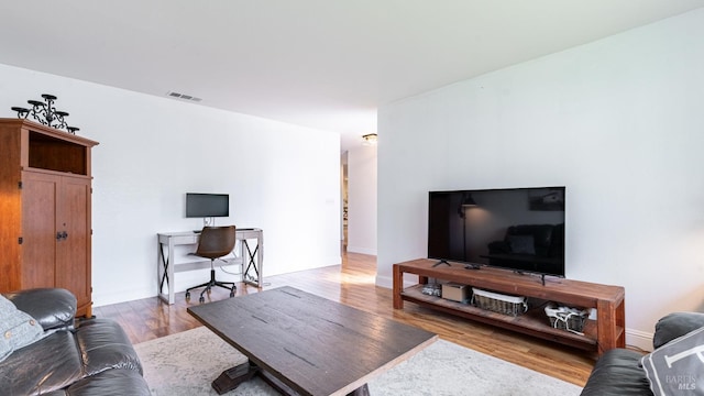living room featuring wood finished floors and visible vents