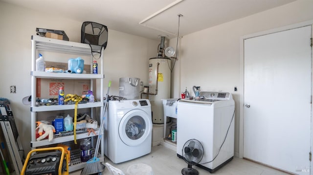 washroom with gas water heater, attic access, laundry area, and a sink