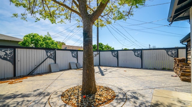 view of patio featuring fence