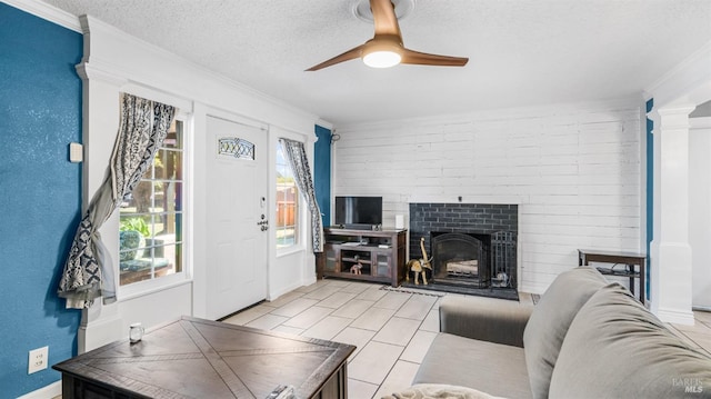 living area with ornamental molding, a textured ceiling, and ceiling fan