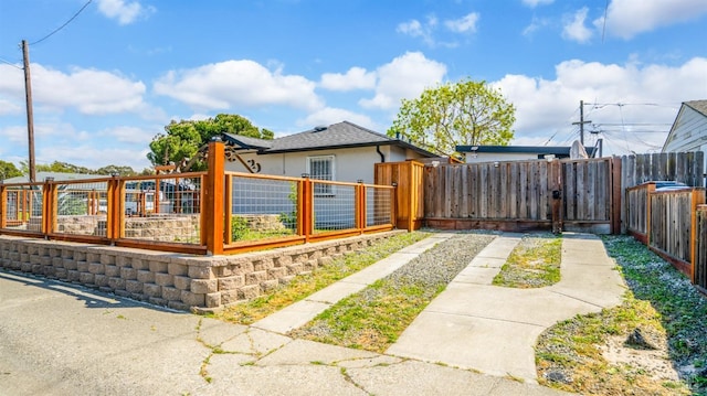 exterior space featuring stucco siding and a fenced front yard