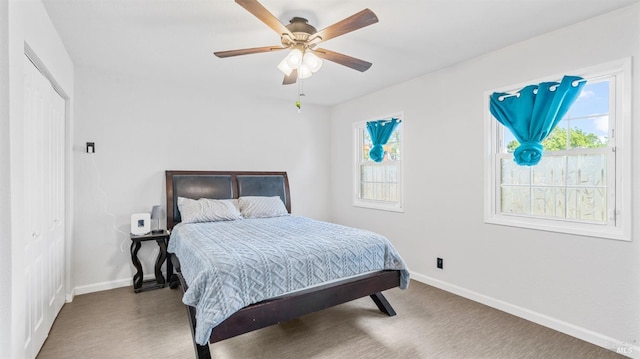 bedroom with a ceiling fan and baseboards