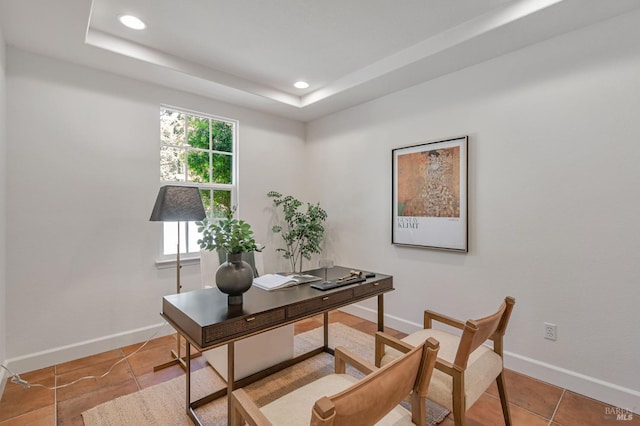 tiled office space featuring baseboards, a tray ceiling, and recessed lighting
