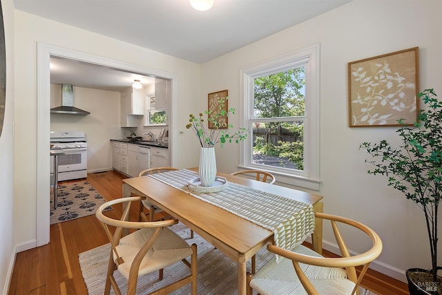 dining space with light wood-style floors and baseboards