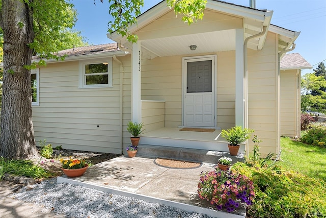 exterior space with roof with shingles