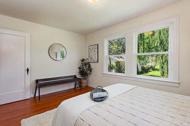 bedroom featuring baseboards and wood finished floors