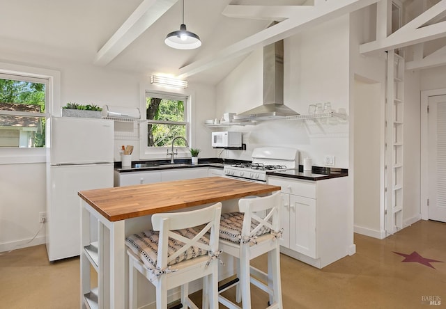 kitchen with open shelves, a sink, white appliances, wall chimney exhaust hood, and butcher block counters