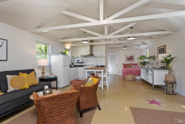 living room with vaulted ceiling with beams