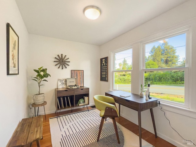 home office featuring baseboards and wood finished floors