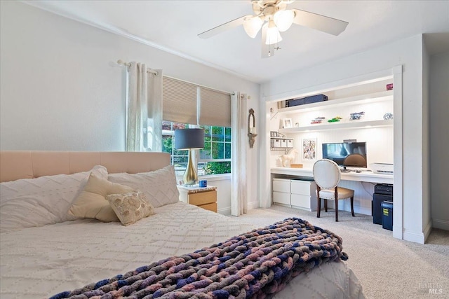 bedroom with carpet flooring, a ceiling fan, baseboards, and built in study area
