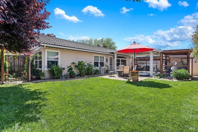 back of house featuring a fenced backyard, a chimney, a patio area, a yard, and a tile roof