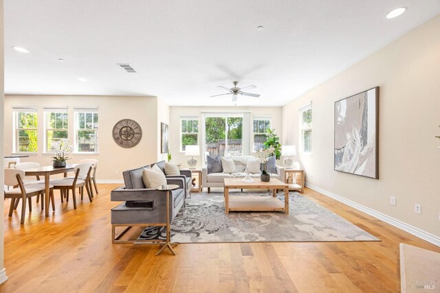 living room with recessed lighting, ceiling fan, light wood-type flooring, visible vents, and baseboards