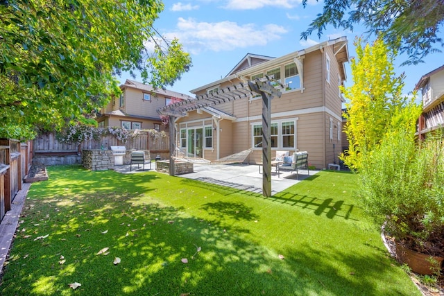back of house with a yard, a pergola, a patio area, and a fenced backyard