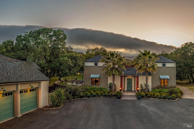 view of front of home with a garage and aphalt driveway