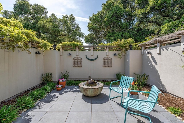 view of patio / terrace featuring a fenced backyard and an outdoor fire pit