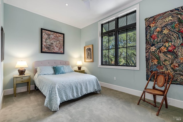 bedroom with carpet flooring, ornamental molding, and baseboards