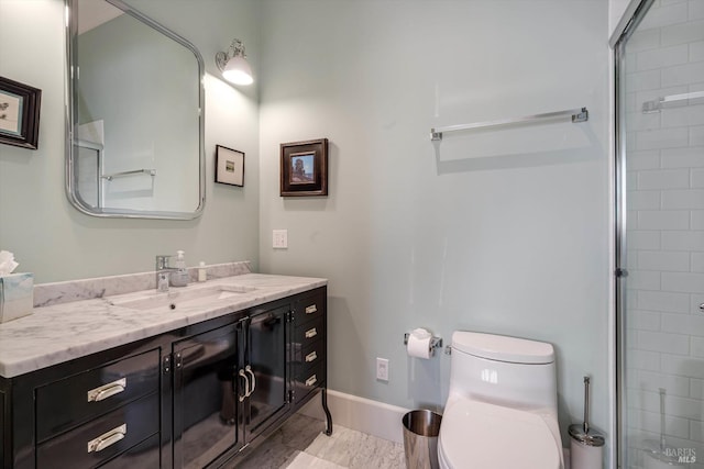 bathroom featuring toilet, a tile shower, vanity, and baseboards