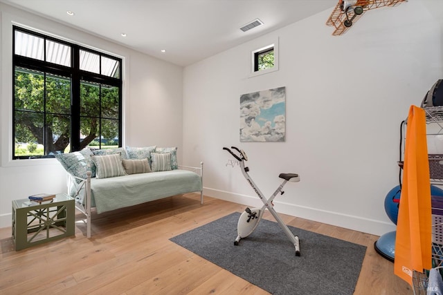 exercise room with visible vents, light wood-type flooring, recessed lighting, and baseboards