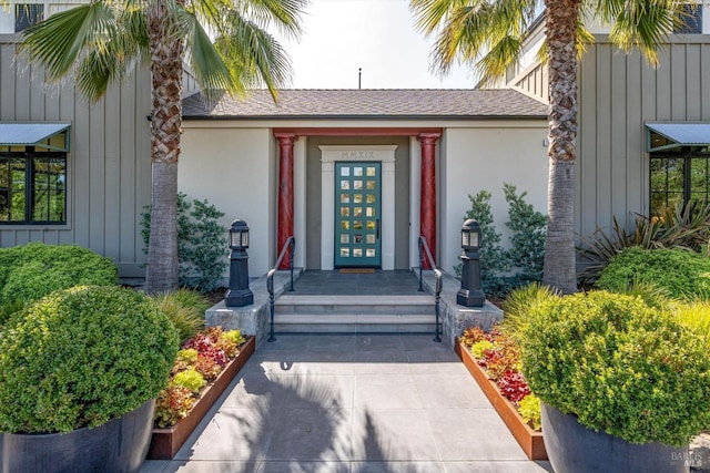 doorway to property featuring stucco siding and french doors