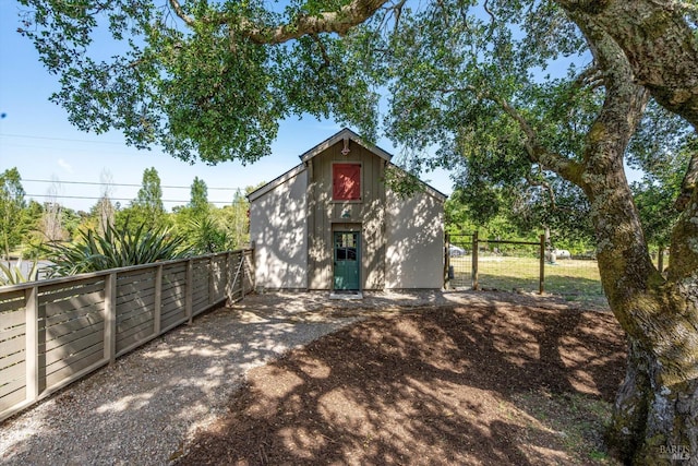 exterior space featuring an outbuilding, a gate, and fence