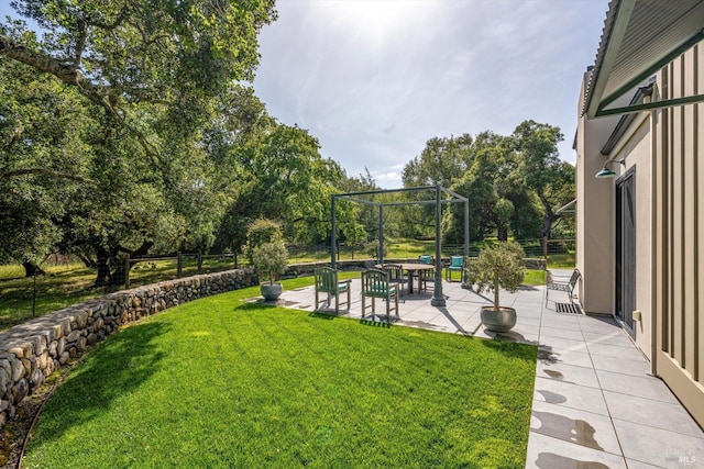 view of yard with fence and a patio