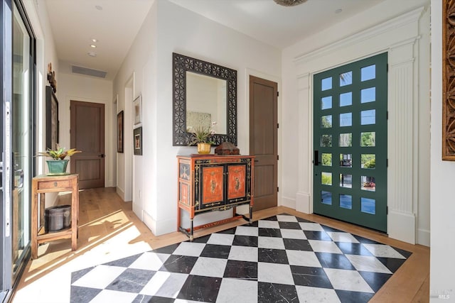 foyer entrance featuring visible vents