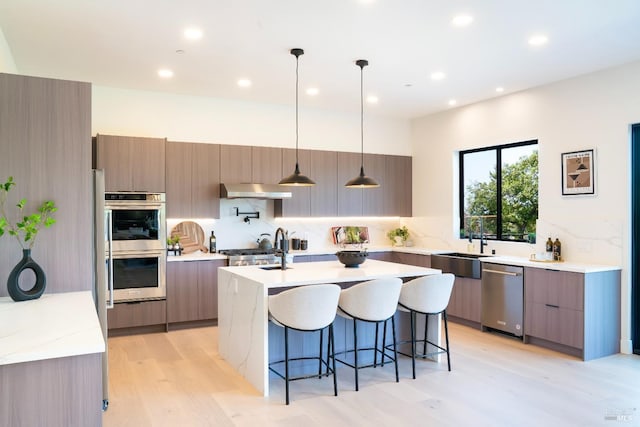 1975 W Bristlecone Ct, Santa Rosa, CA 95403 - kitchen with appliances with stainless steel finishes, modern cabinets, a kitchen breakfast bar, light wood-style flooring, and a sink