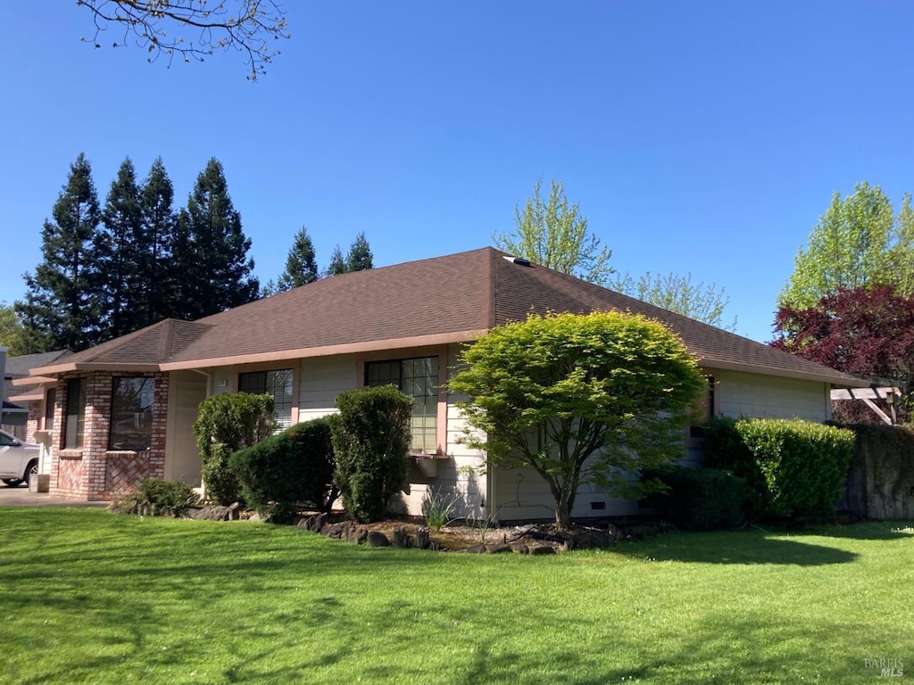 view of side of home featuring a yard