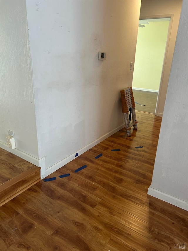 interior space featuring wood finished floors and baseboards