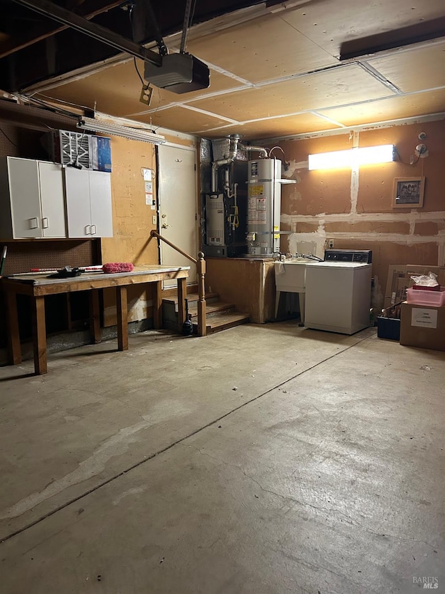 garage featuring a garage door opener, a workshop area, washer / dryer, and heating unit