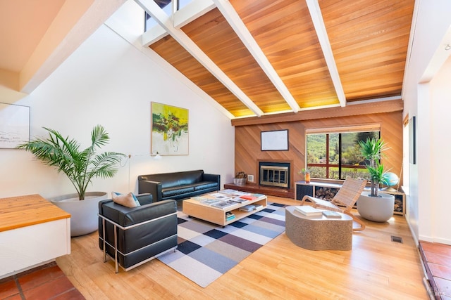 2200 Mcnab Ranch Rd, Ukiah, CA 95482 - living room featuring wood walls, visible vents, a glass covered fireplace, wood finished floors, and vaulted ceiling with beams